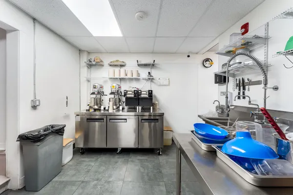 a kitchen with stainless steel appliances granite countertop a sink a stove and wooden cabinets