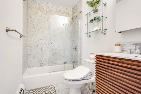 a bathroom with a sink a toilet and shower