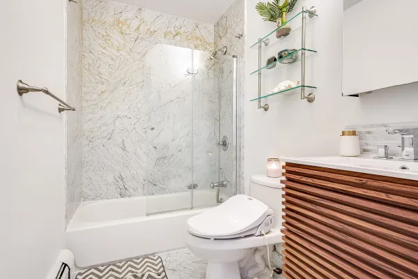 a bathroom with a sink a toilet and shower