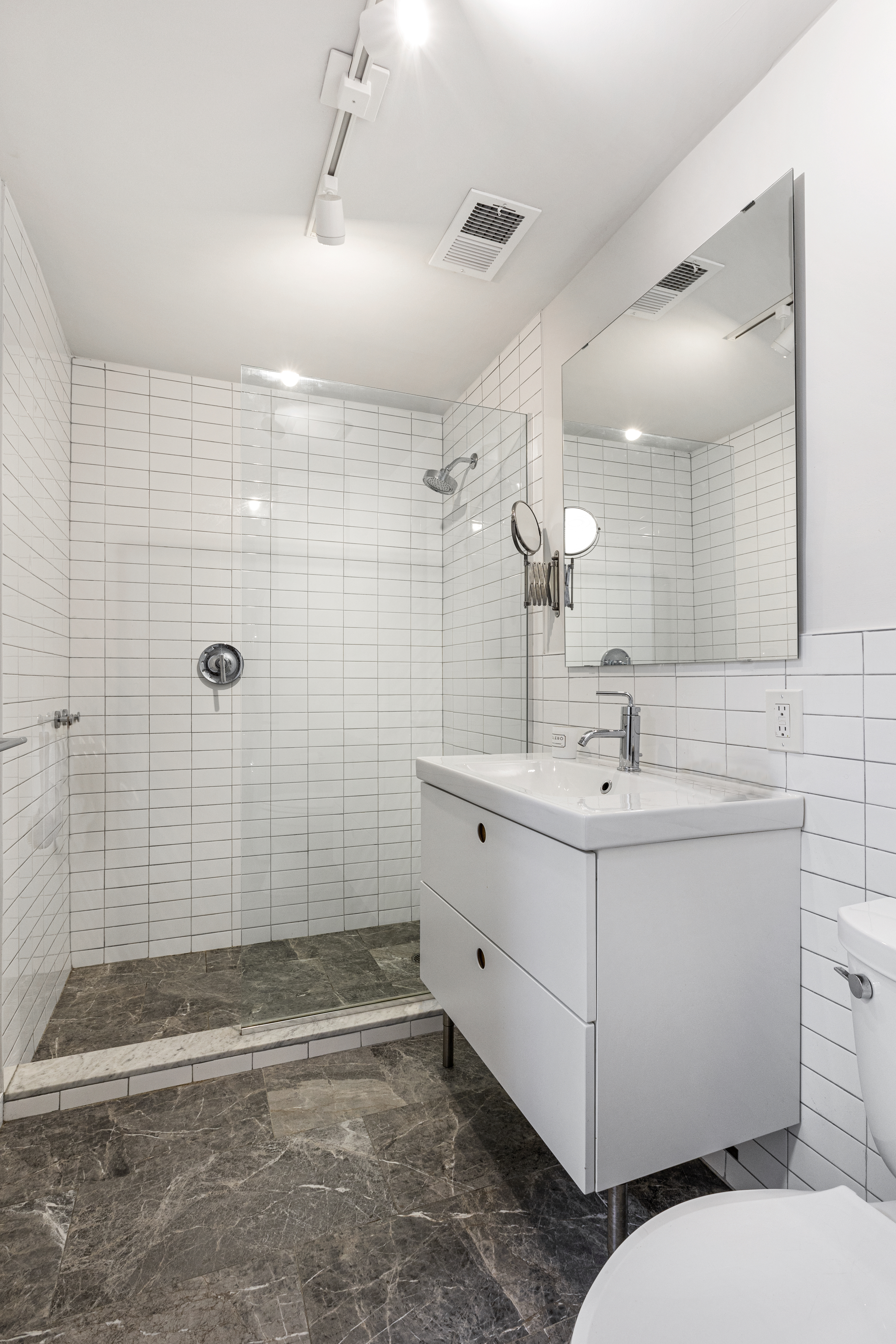 329 Grand Avenue, Unit B Brooklyn, NY 11238 - Photo 6 of 9 a bathroom with double sink and a shower