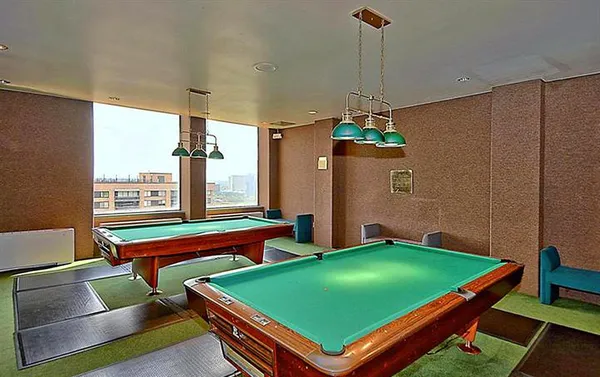 a room with pool table and windows