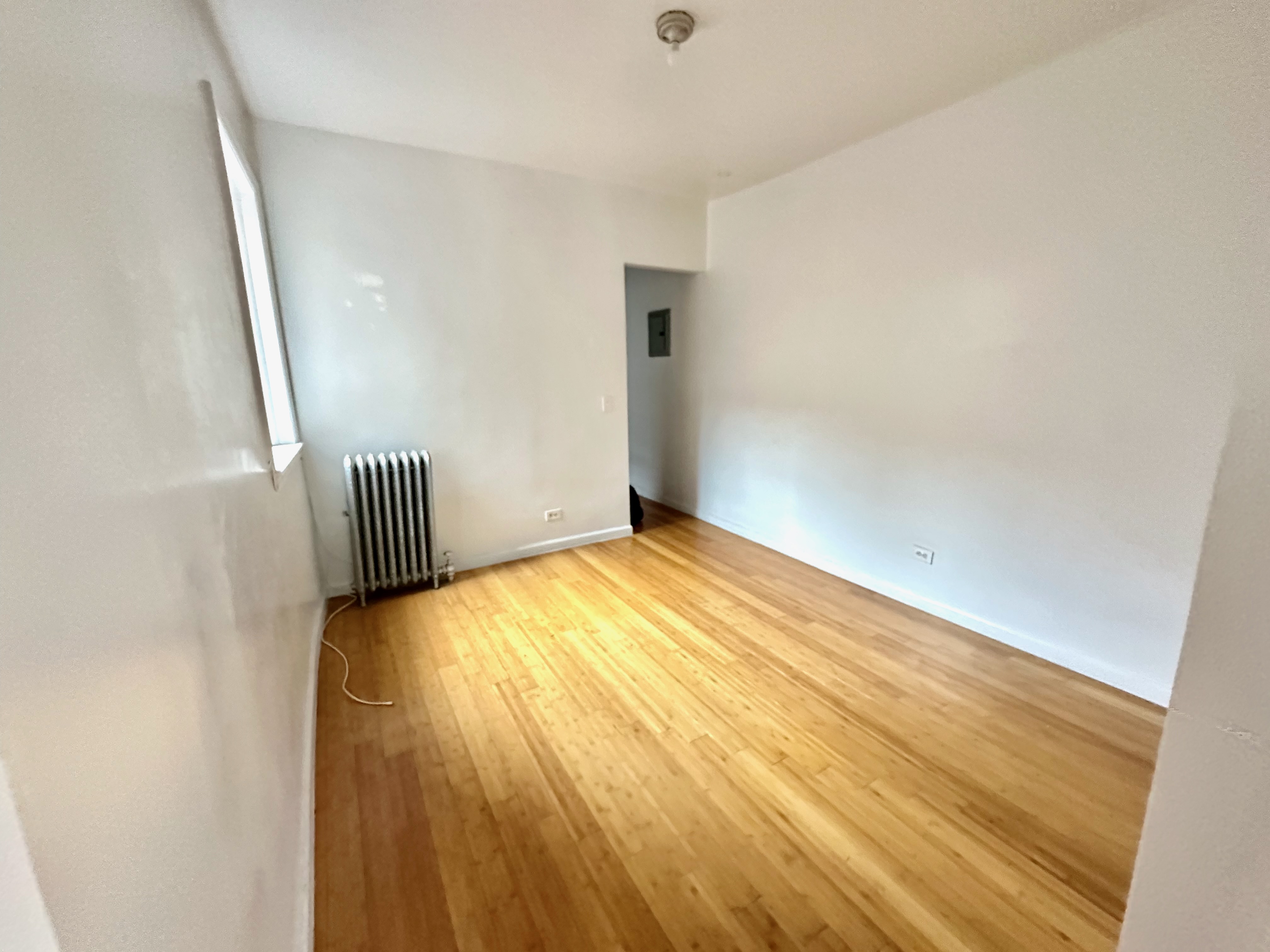 541 West 144th Street, Unit 17 Manhattan, NY 10031 - Photo 3 of 6 a view of empty room with wooden floor