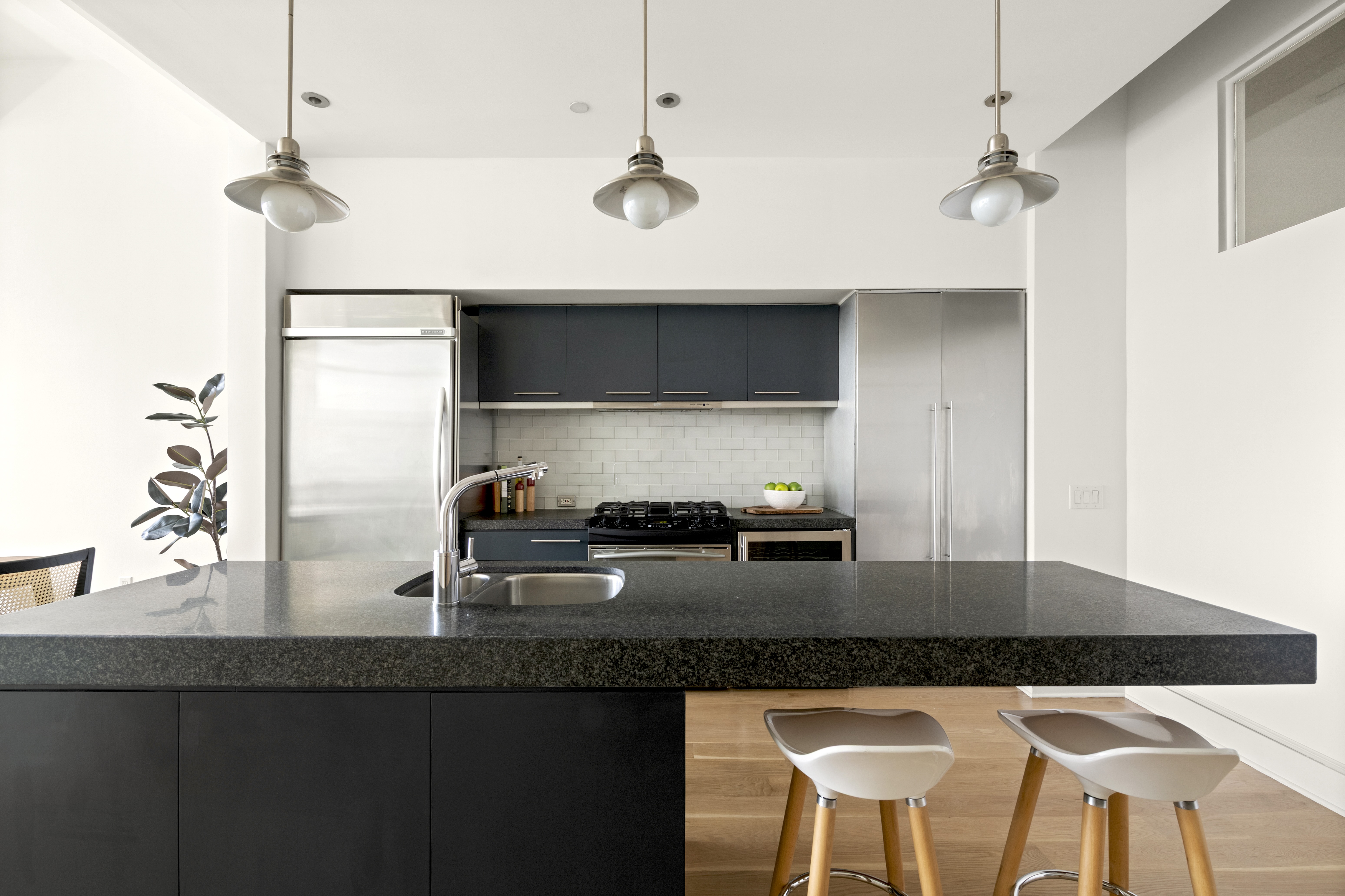 55 Berry Street, Unit 4B Brooklyn, NY 11249 - Photo 3 of 12 a kitchen with granite countertop a sink a stove and refrigerator