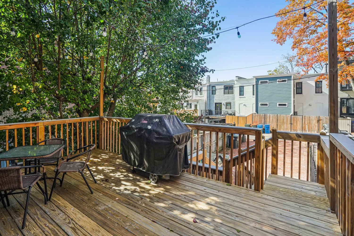 a view of a house with wooden deck and furniture