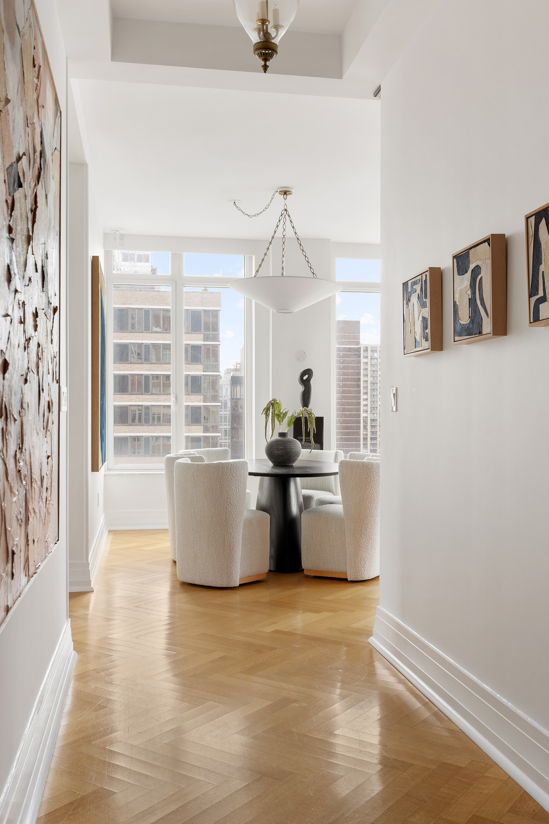 205 East 85th Street, Unit 19B Manhattan, NY 10028 - Photo 4 of 9 a living room with a couch and a potted plant