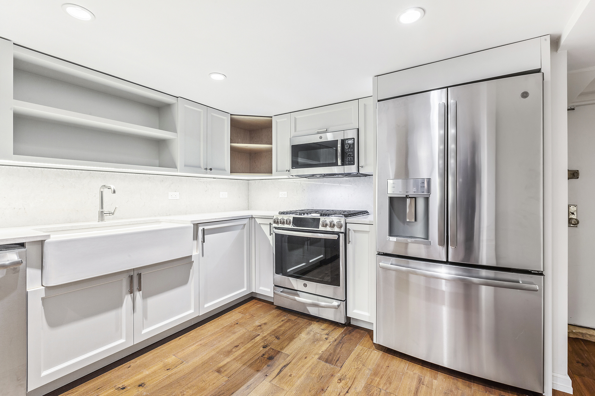 522 East 82nd Street, Unit 1 Manhattan, NY 10028 - Photo 5 of 16 a kitchen with a refrigerator stove and sink