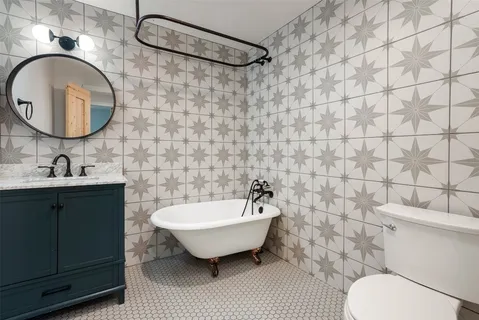 a bathroom with a sink mirror and toilet