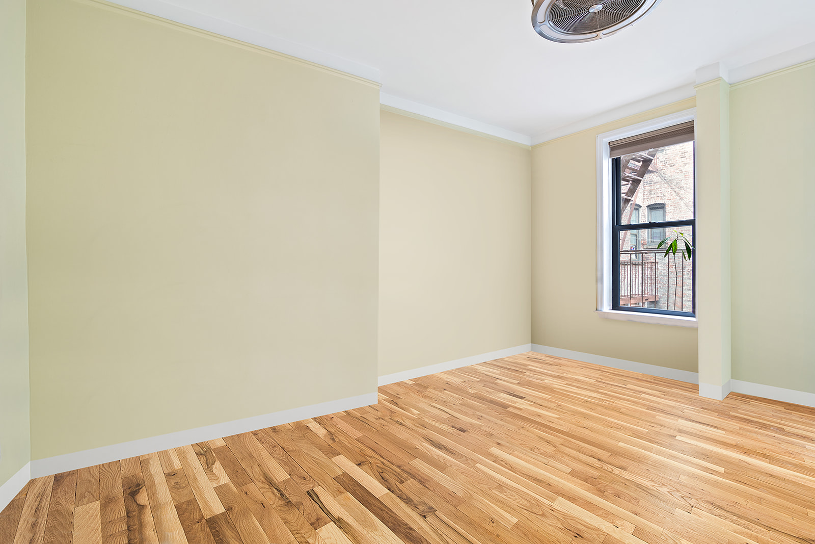 660 Riverside Drive, Unit 4D Manhattan, NY 10031 - Photo 2 of 6 a bedroom with a bed and a window