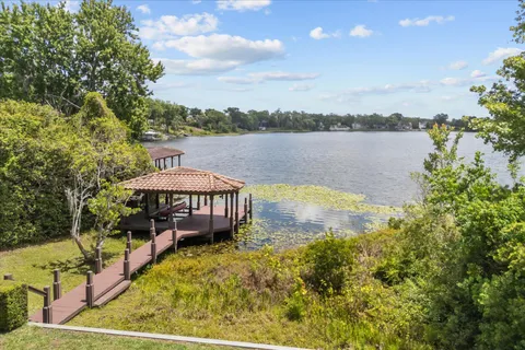 a view of a swimming pool with a patio and a yard