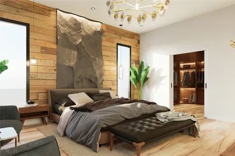 a bedroom with furniture and a large window