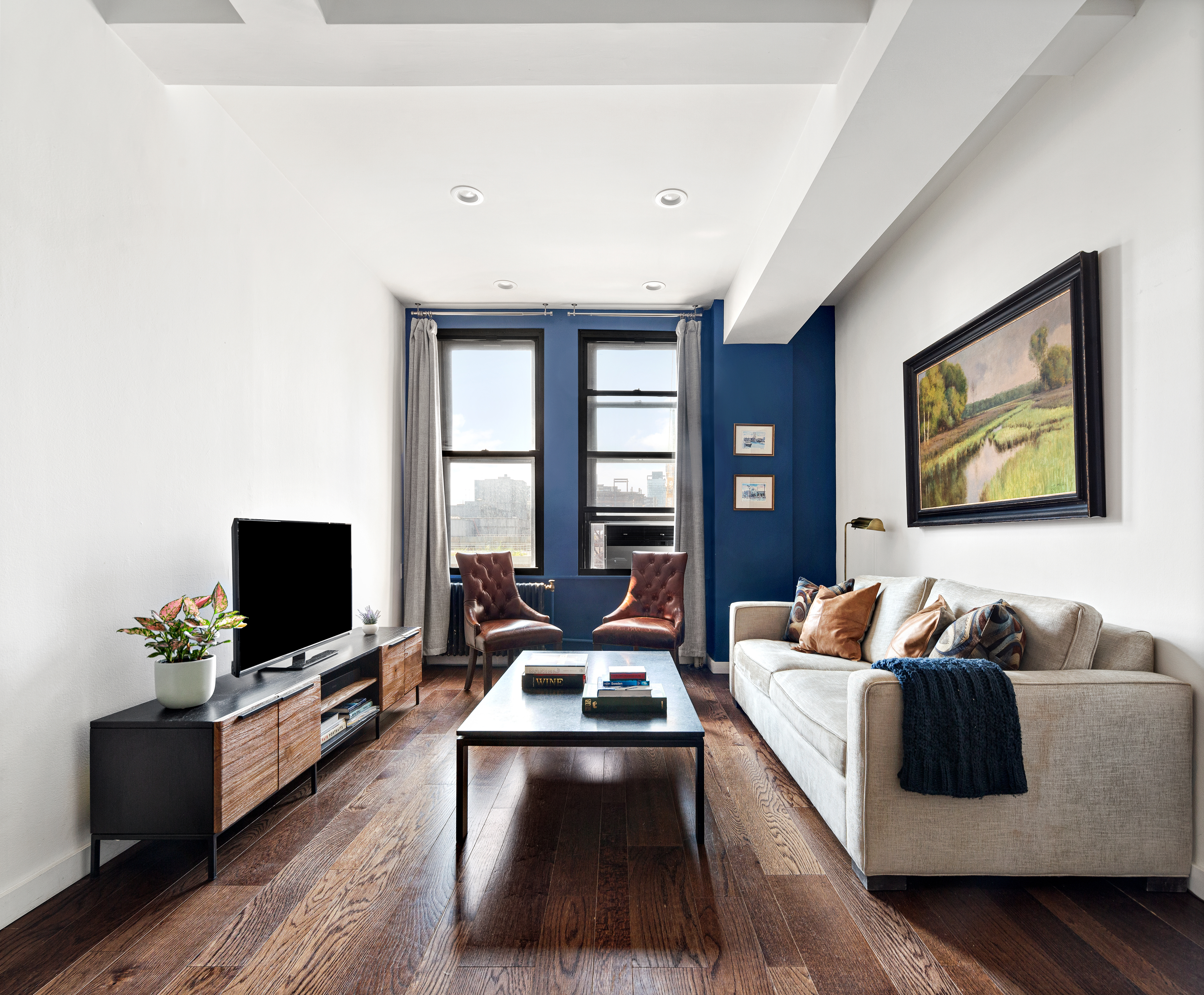 315 7th Avenue, Unit 9B Manhattan, NY 10001 - Photo 1 of 8 a living room with furniture and a flat screen tv