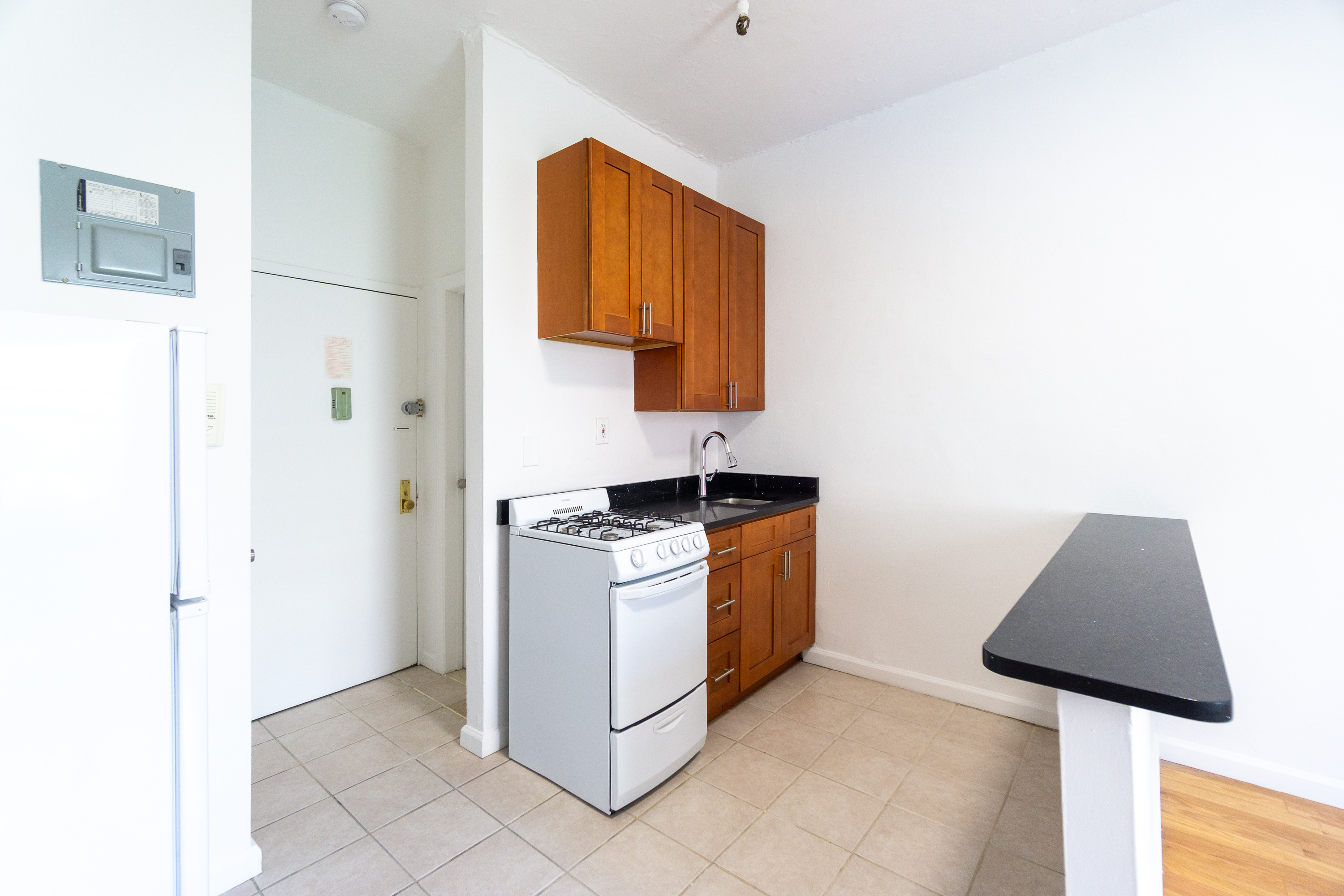 320 West 20th Street, Unit 15 Manhattan, NY 10011 - Photo 4 of 14 a kitchen with stainless steel appliances granite countertop a sink and a refrigerator