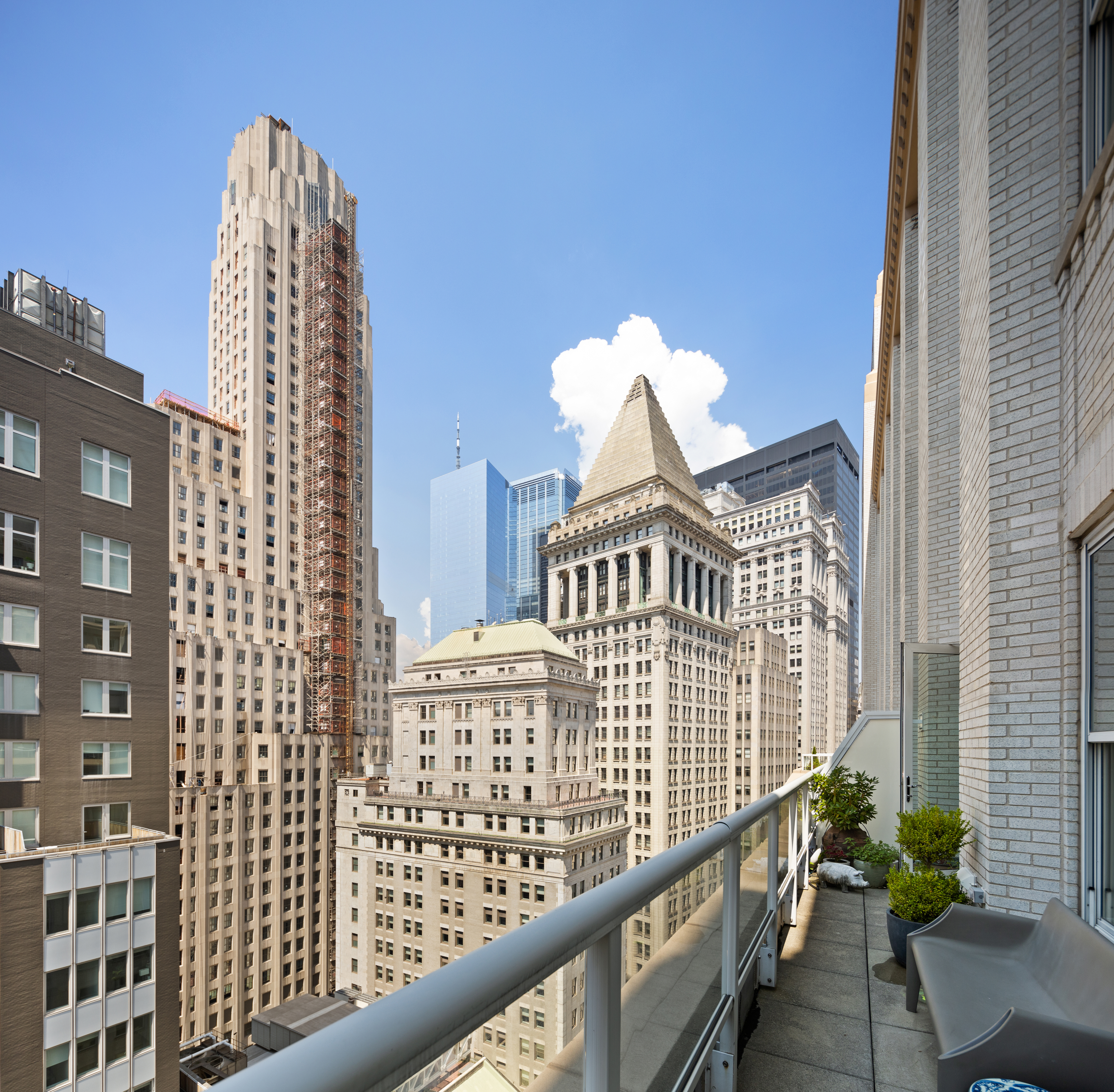 15 Broad Street, Unit 2416 Manhattan, NY 10005 - Photo 4 of 25 a view of a balcony with a potted plant