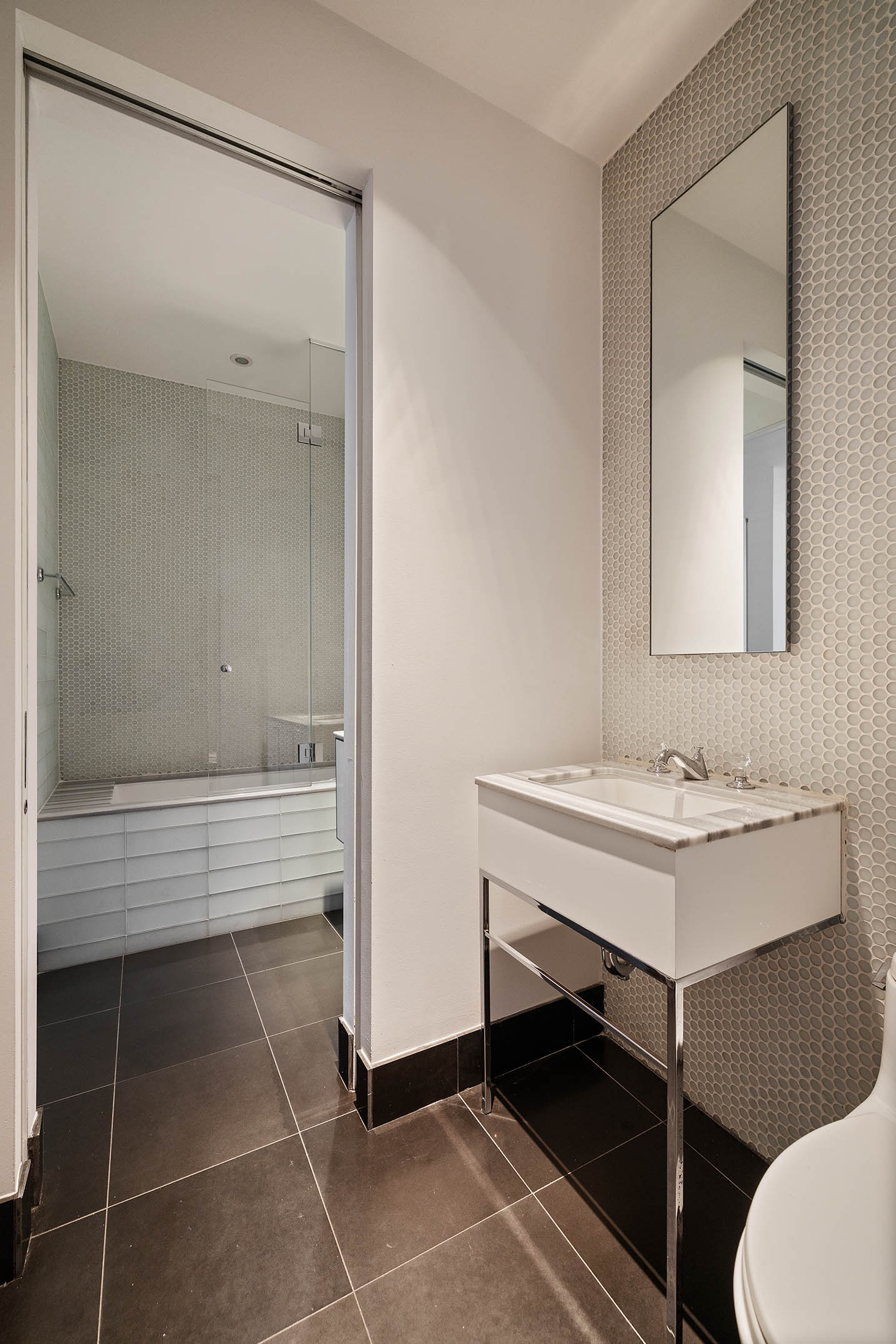 25 Broad Street, Unit 16I Manhattan, NY 10004 - Photo 16 of 23 a bathroom with a sink and a mirror