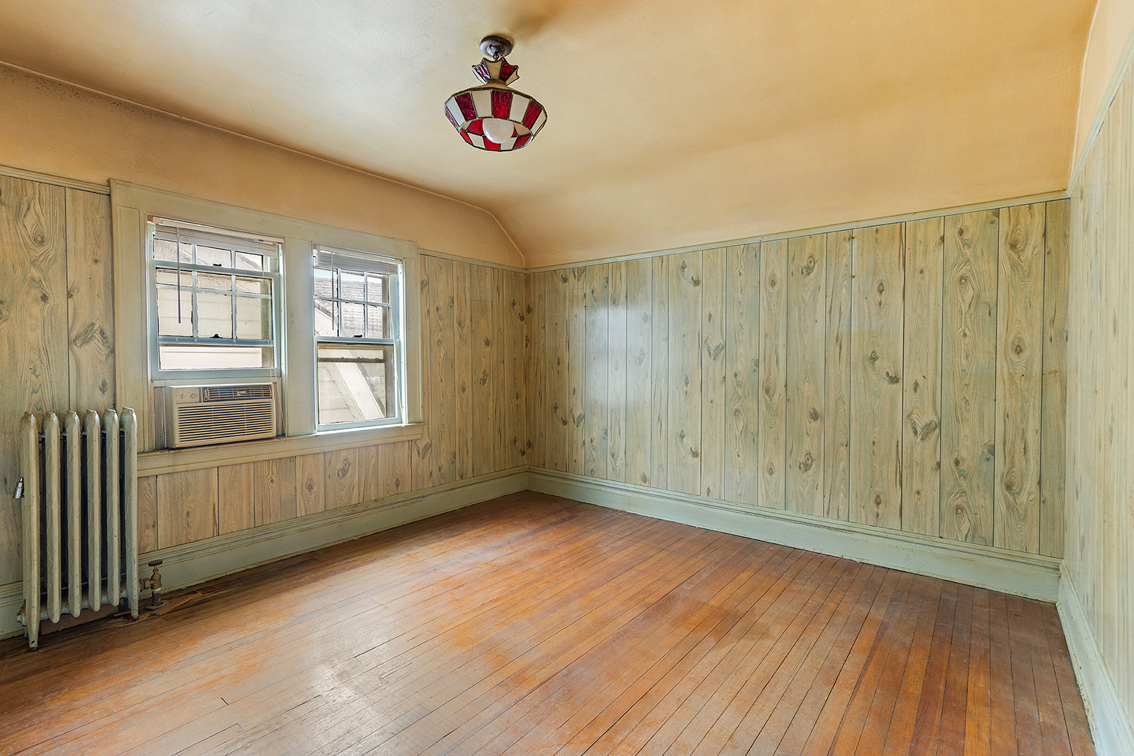 2411 Avenue M Brooklyn, NY 11210 - Photo 9 of 12 a view of an empty room with wooden floor and a window