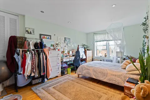 a bedroom with a bed and a window