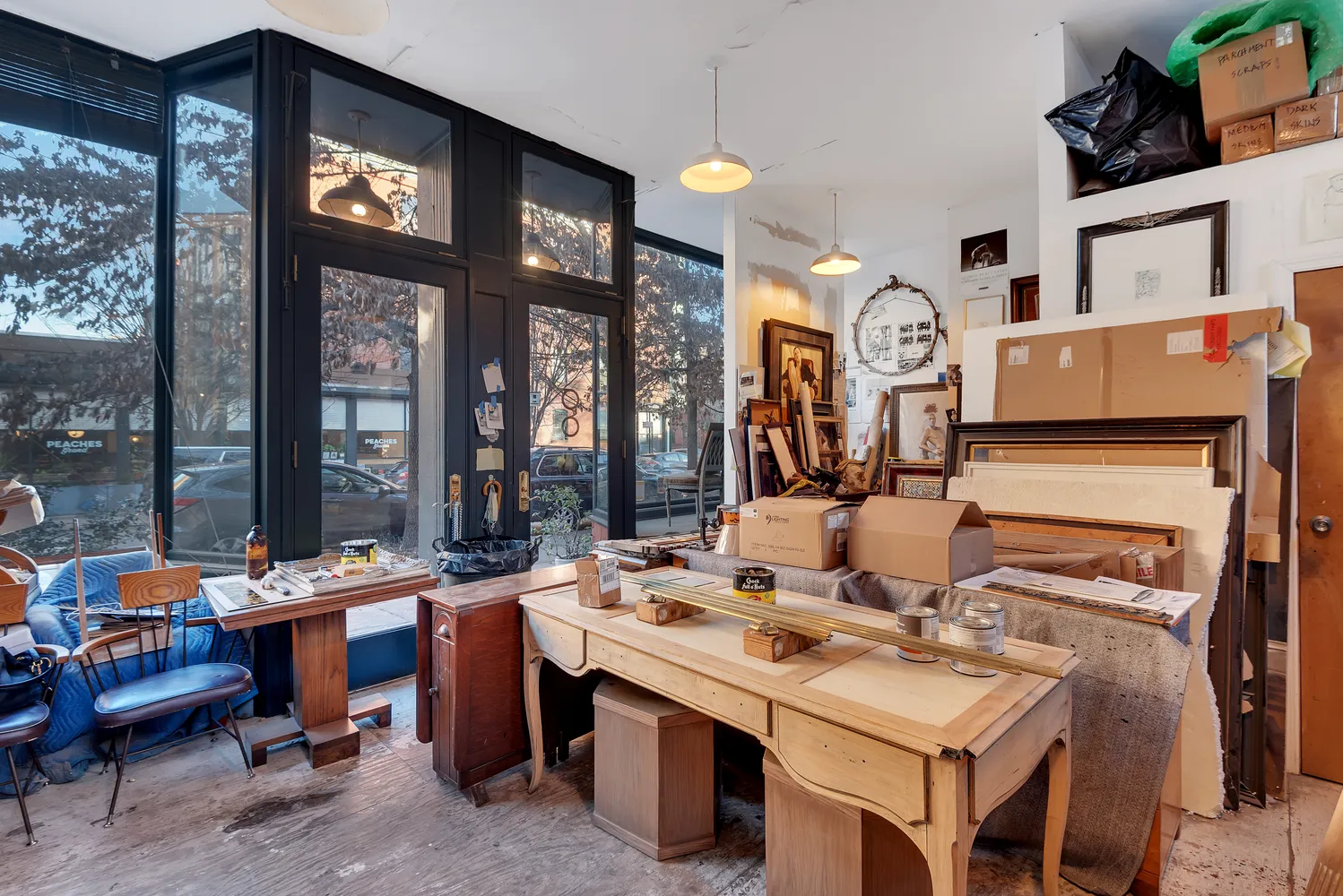 a room with a large window and furniture