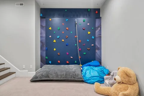 a living room with a bed furniture and a stairs