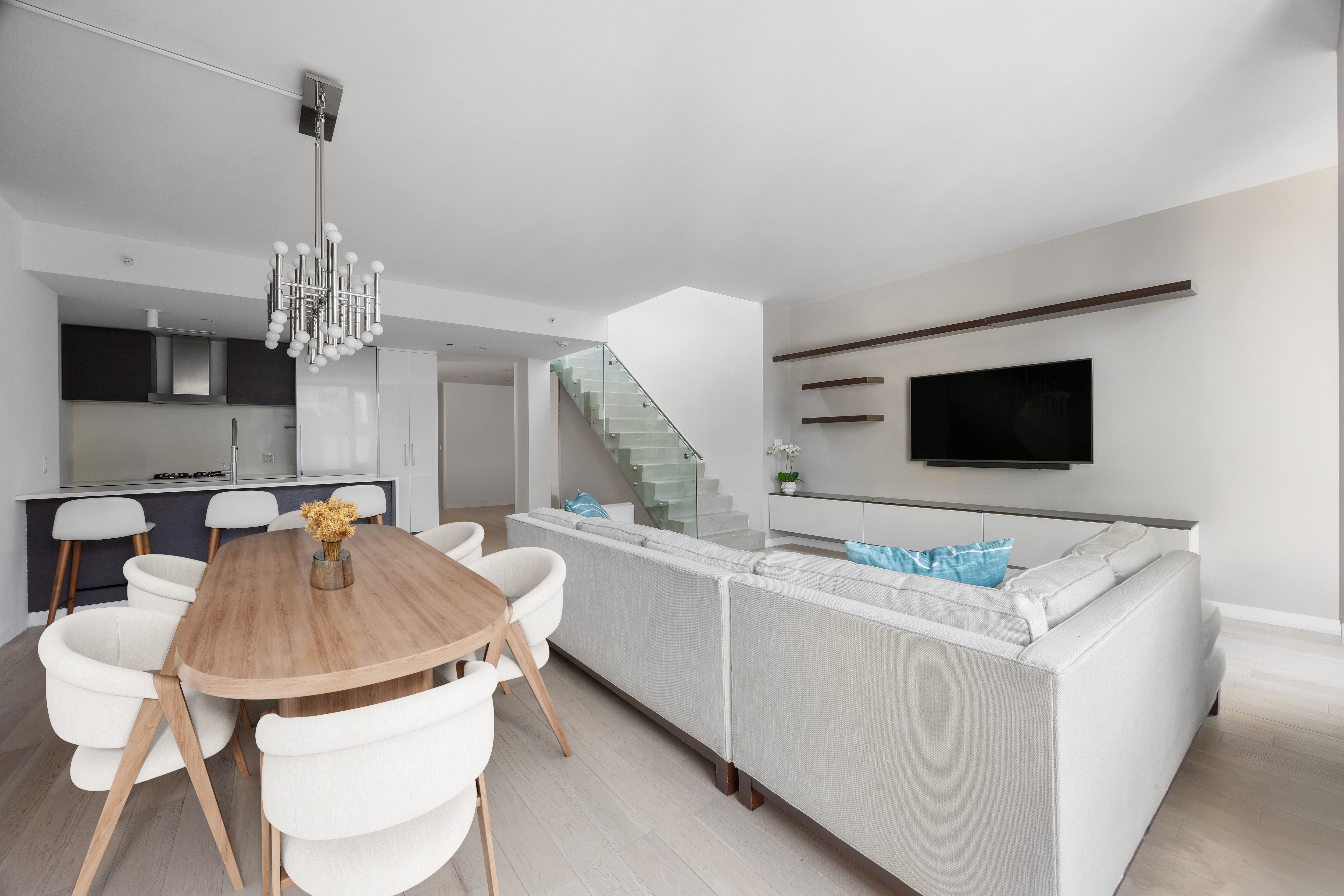 540 West 49th Street, Unit PH1N Manhattan, NY 10019 - Photo 3 of 18 a living room with furniture and a flat screen tv