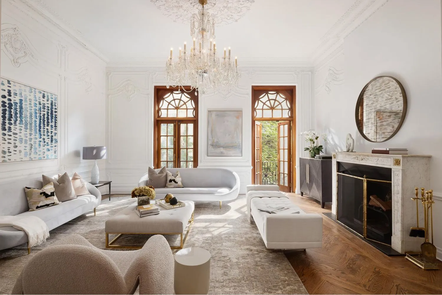 a living room with furniture a chandelier and a fireplace