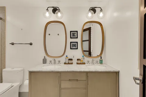 a bathroom with a shower a toilet and sink