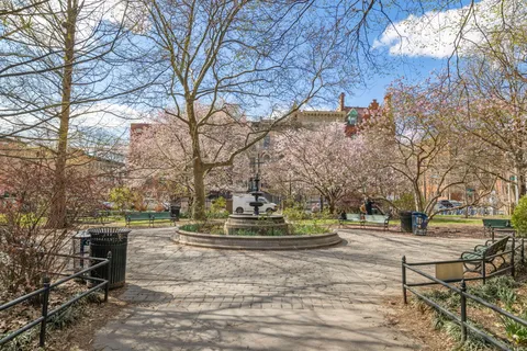 a swimming pool with trees in the background