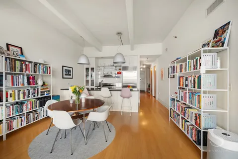 a living room with lots of furniture and a book shelf