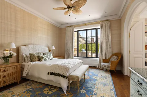 a spacious bedroom with a bed and a flat screen tv