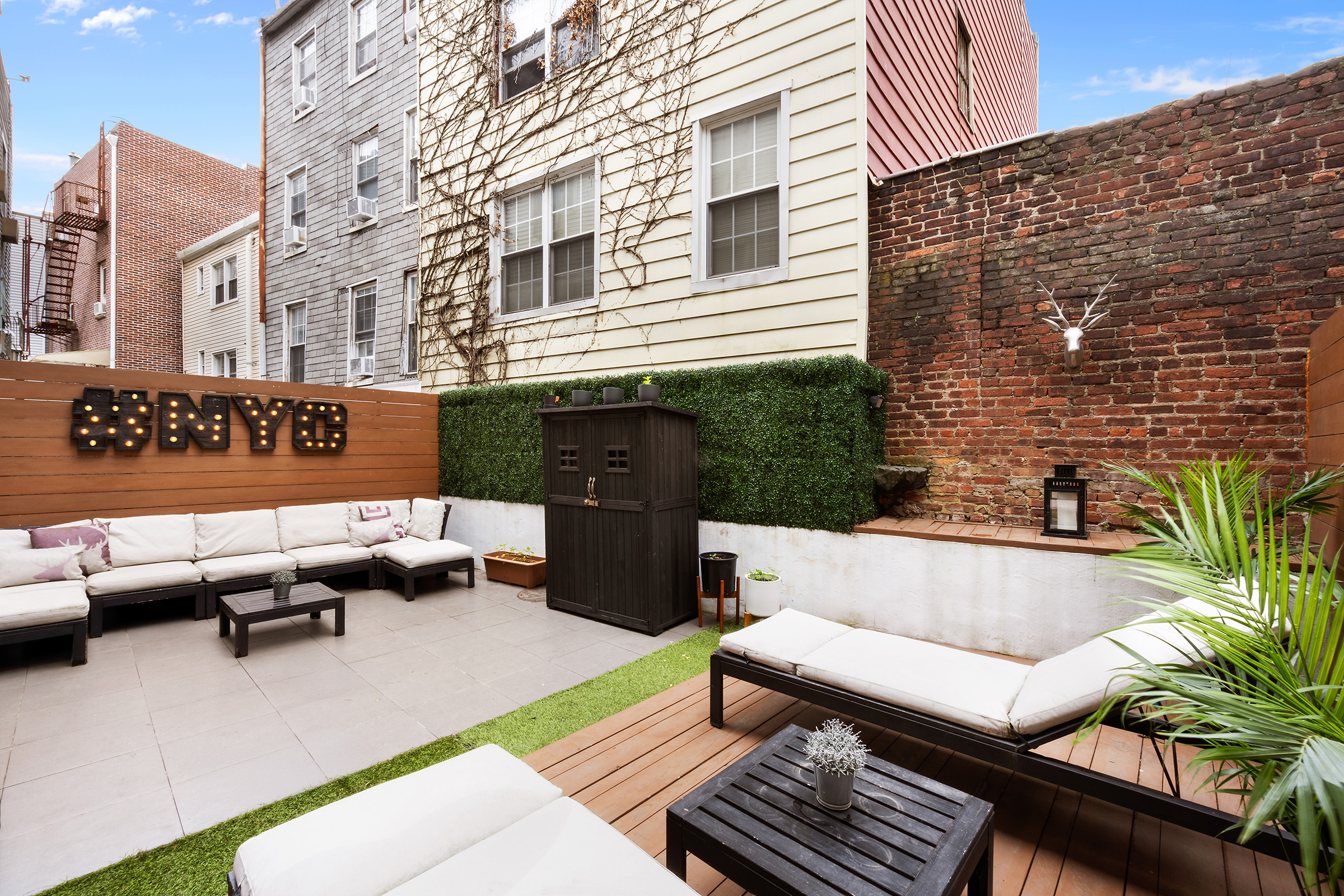 138 North 3rd Street, Unit 1 Brooklyn, NY 11249 - Photo 1 of 8 a balcony with outdoor seating and benches