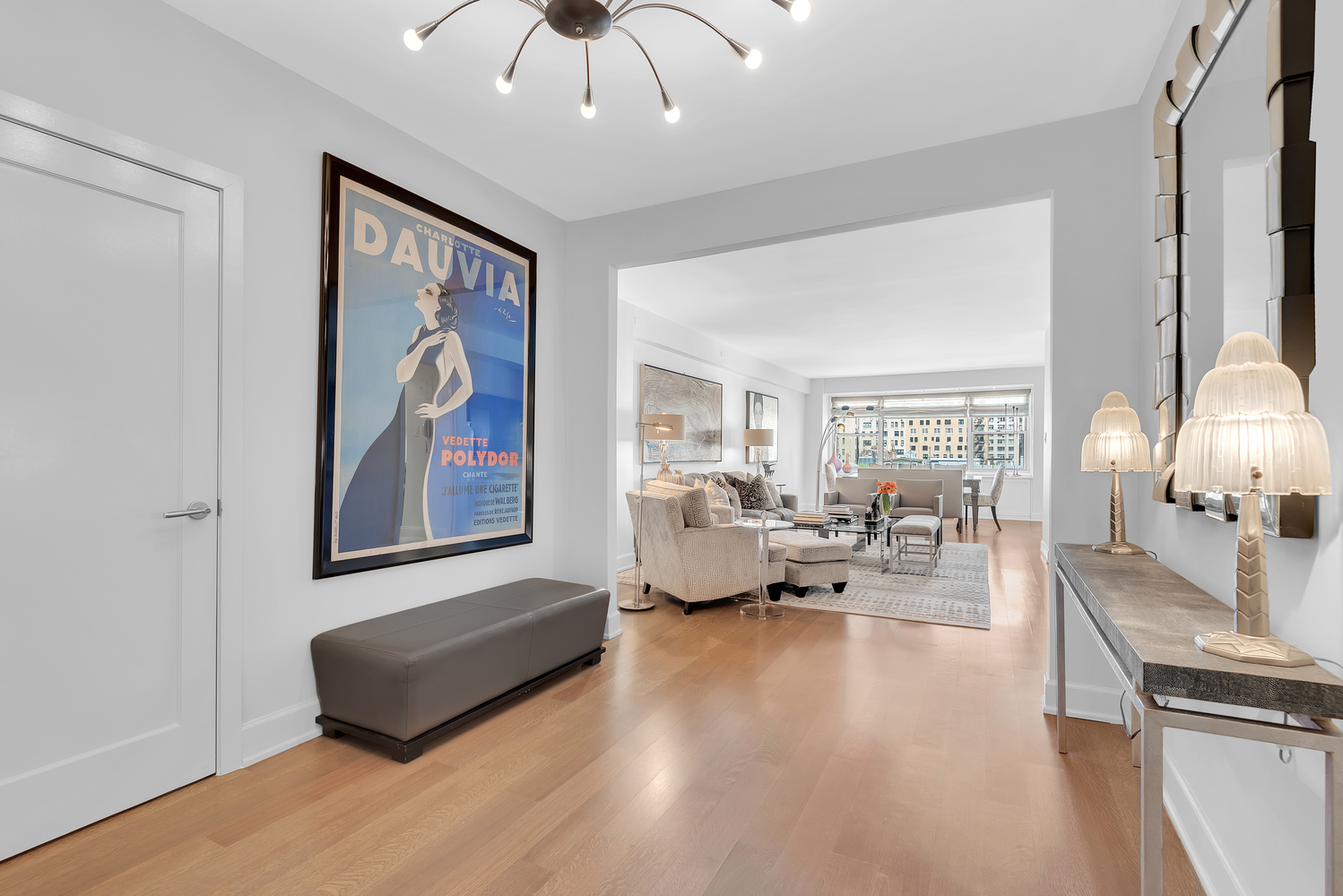 150 East 69th Street, Unit 8J Manhattan, NY 10021 - Photo 5 of 13 a living room with furniture flowerpot and a chandelier