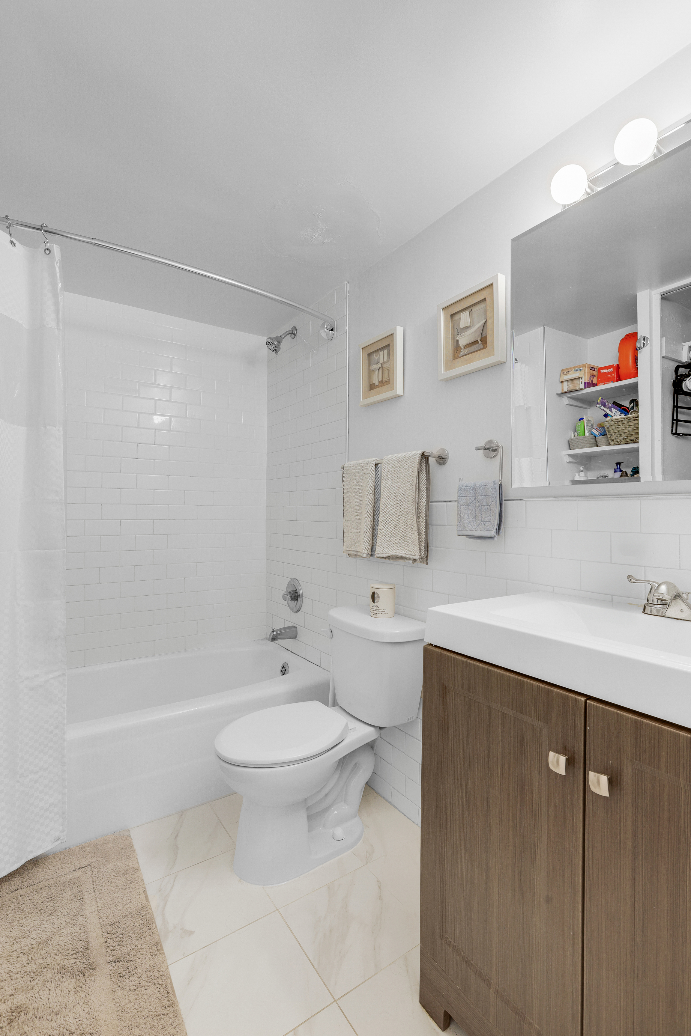 330 East 49th Street, Unit 9A Manhattan, NY 10017 - Photo 4 of 7 a bathroom with a sink toilet and shower