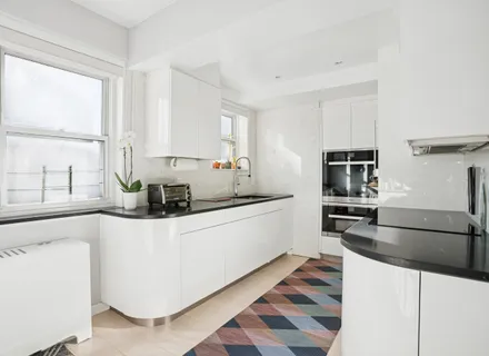 a kitchen with stainless steel appliances granite countertop a sink and a stove