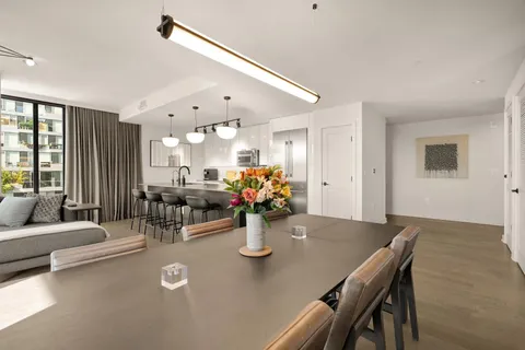 a view of a dining room with furniture and chandelier