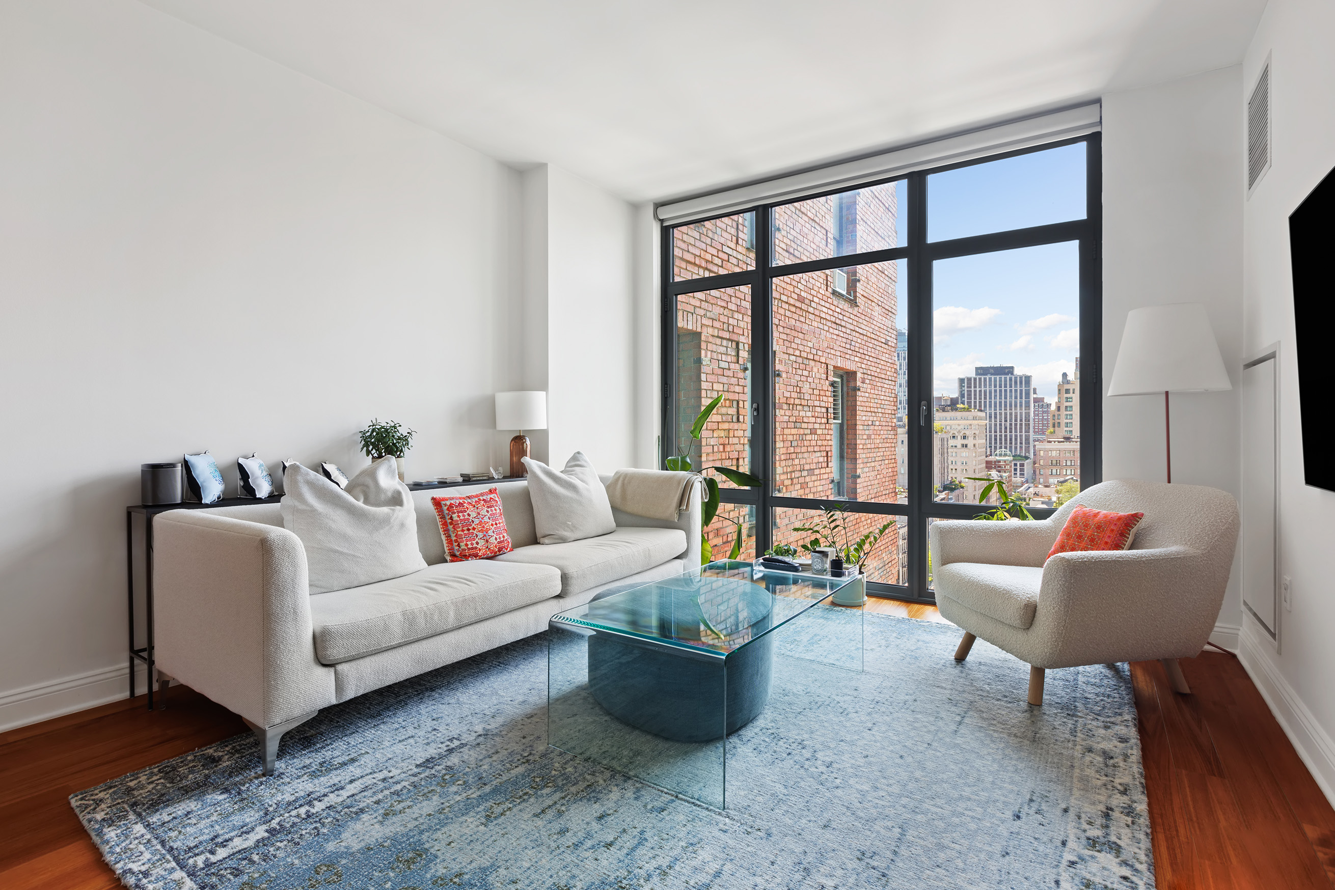 57 Reade Street, Unit 14C Manhattan, NY 10007 - Photo 2 of 16 a living room with furniture and a large window