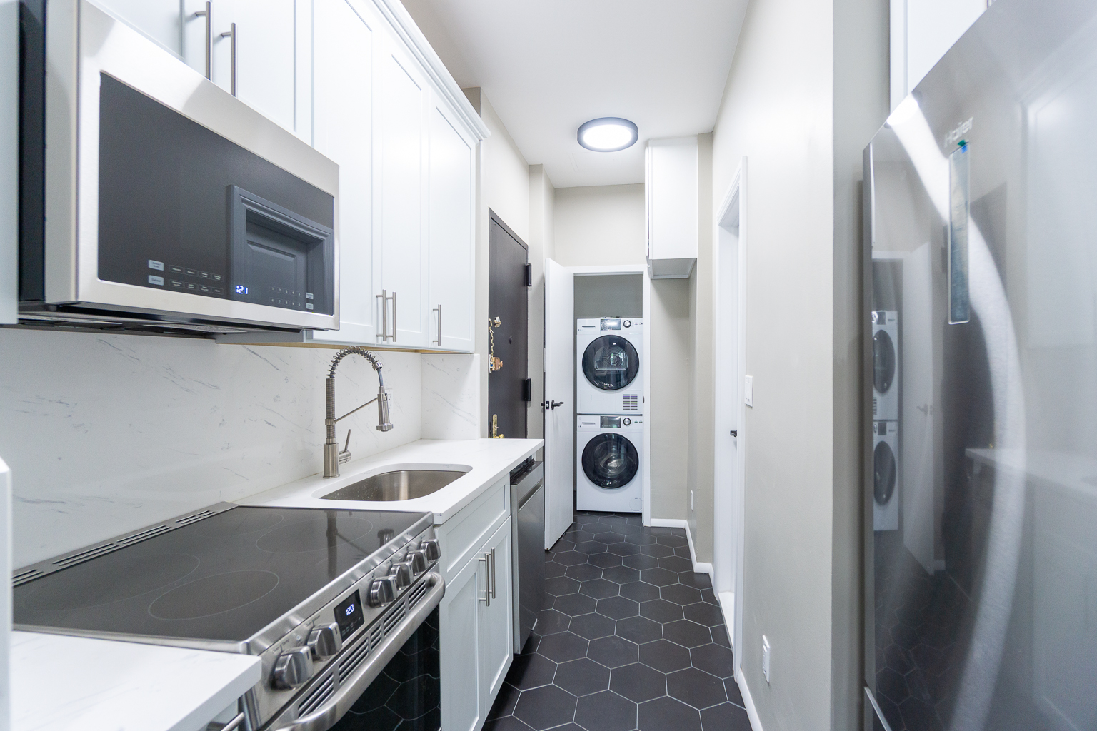 338 East 5th Street, Unit 5 Manhattan, NY 10003 - Photo 6 of 11 a kitchen with a refrigerator and a sink