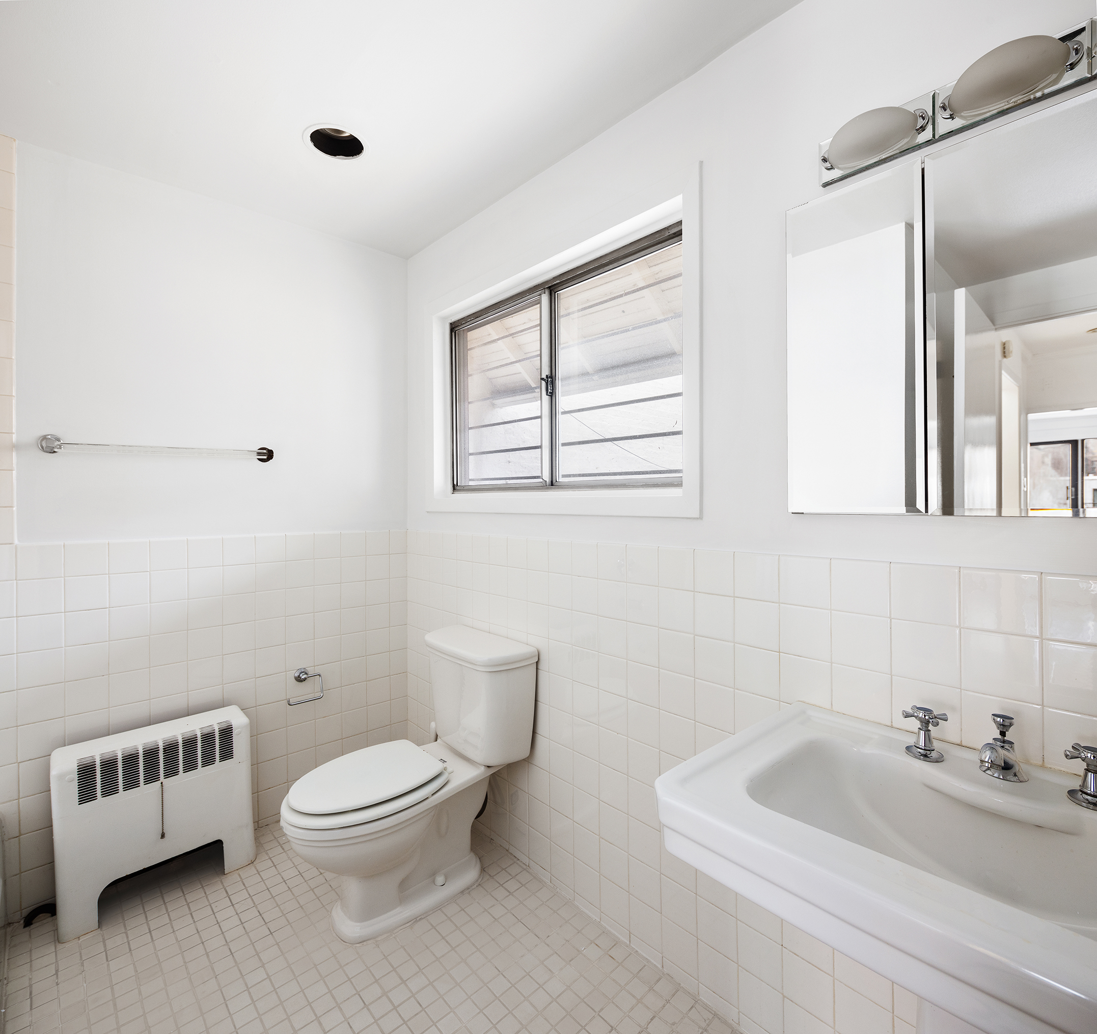 7 East 74th Street, Unit PH Manhattan, NY 10021 - Photo 9 of 10 a white toilet sitting next to a bathroom sink