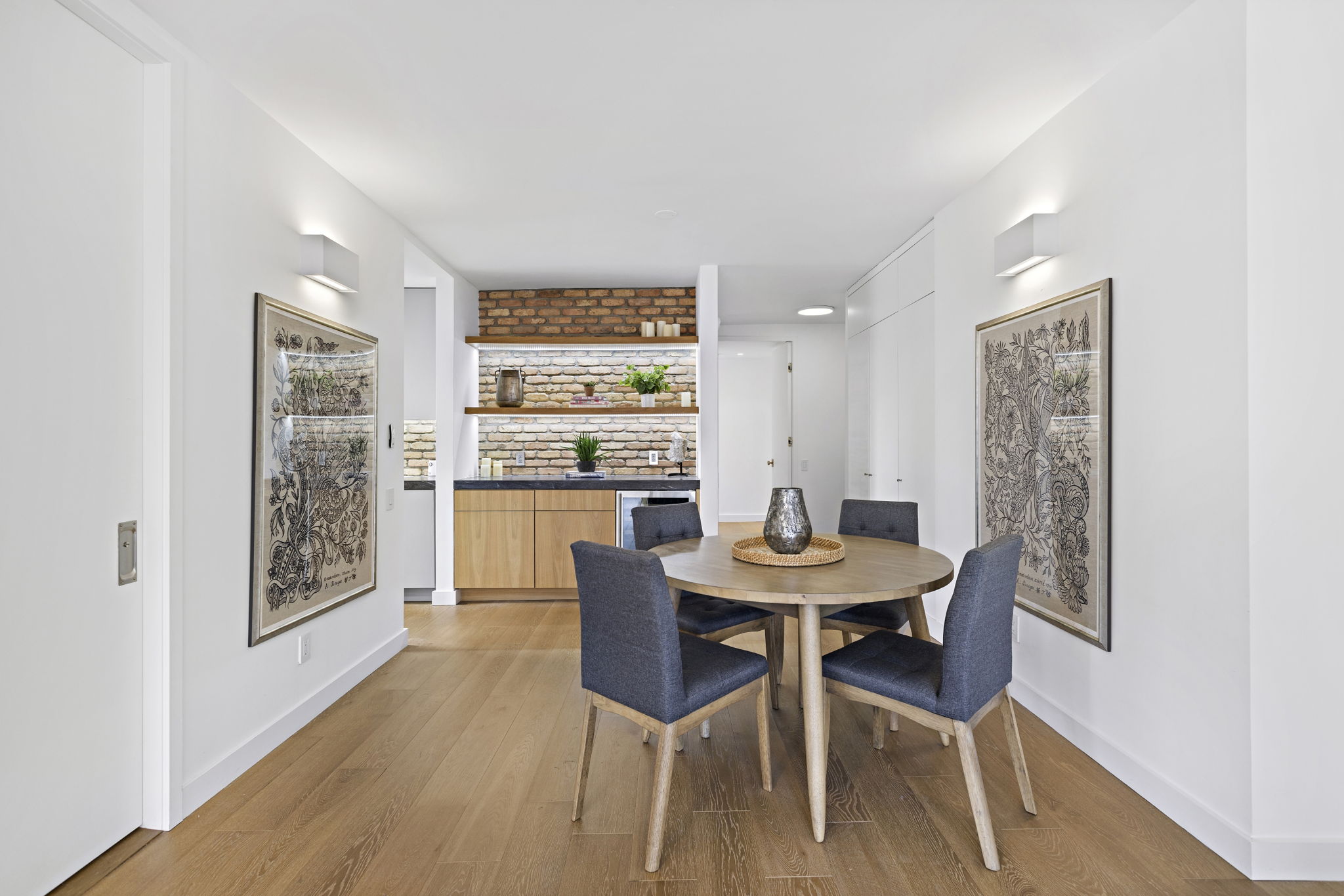 117 East 57th Street, Unit 21H Manhattan, NY 10022 - Photo 8 of 25 a view of a dining room with furniture and wooden floor