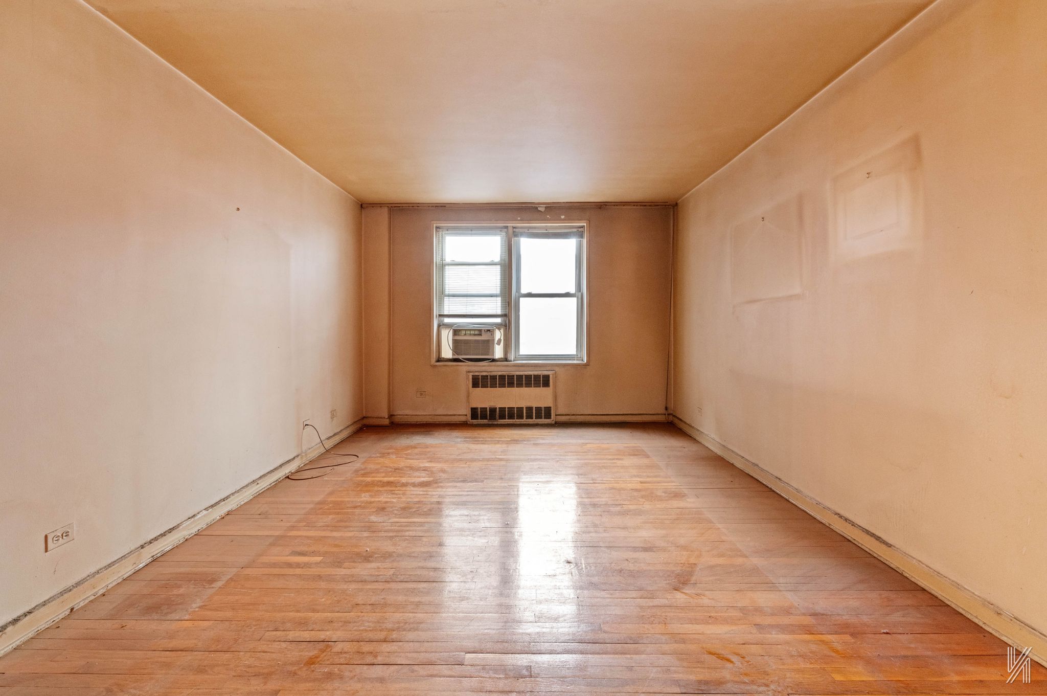 33-05 90th Street, Unit 4F Queens, NY 11372 - Photo 3 of 18 an empty room with wooden floor and windows
