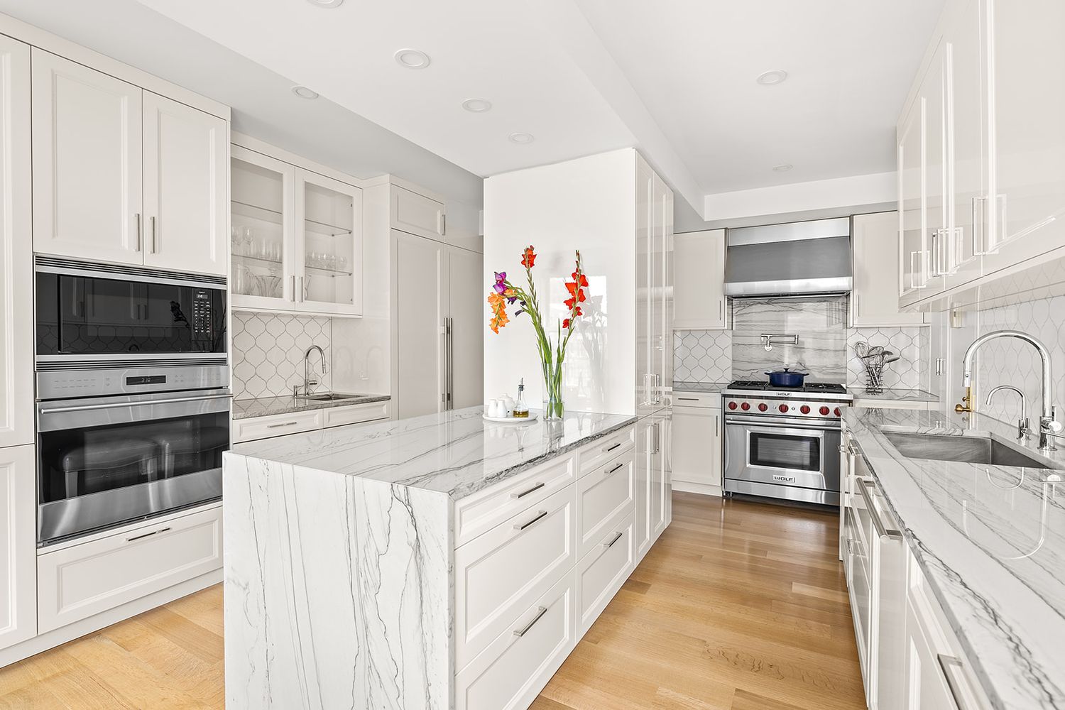 240 West End Avenue, Unit PH Manhattan, NY 10023 - Photo 4 of 25 a kitchen with stainless steel appliances and white cabinets