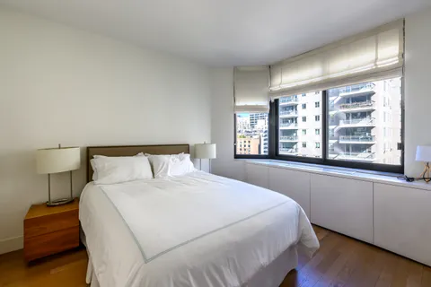 a bedroom with a large bed and a large window