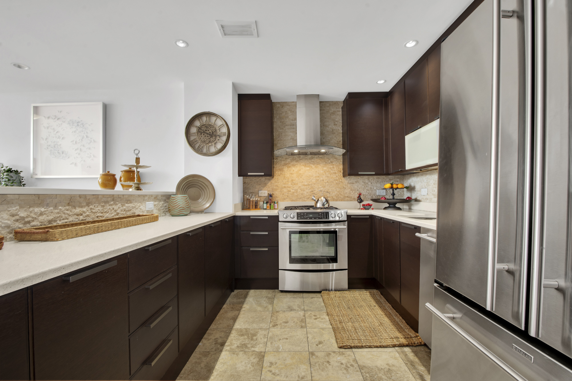 301 West 118th Street, Unit PH1F Manhattan, NY 10026 - Photo 7 of 15 a kitchen with granite countertop stainless steel appliances and wooden cabinets