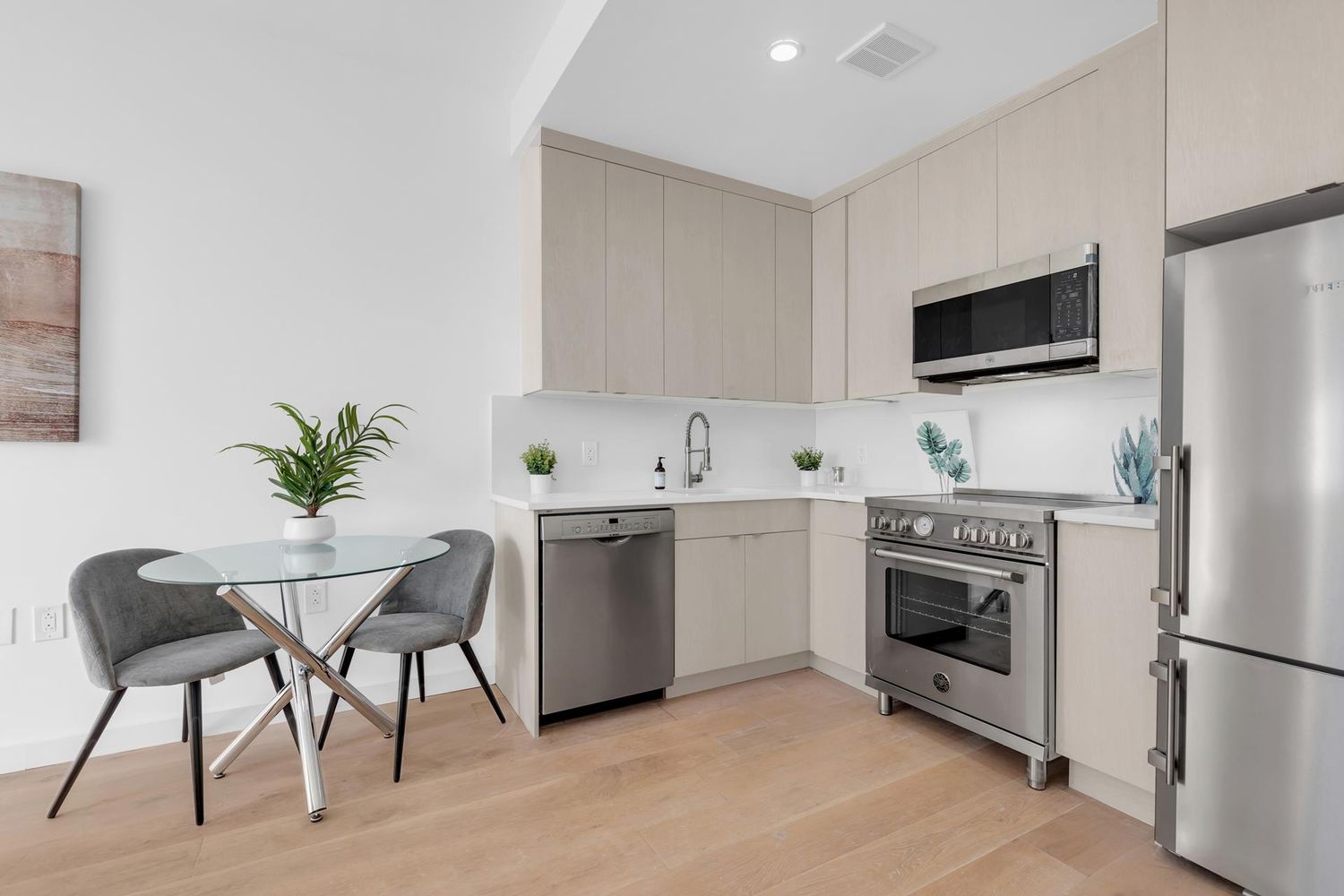 250 Manhattan Avenue, Unit 3F Brooklyn, NY 11211 - Photo 3 of 7 a kitchen with stainless steel appliances a stove a sink and a microwave