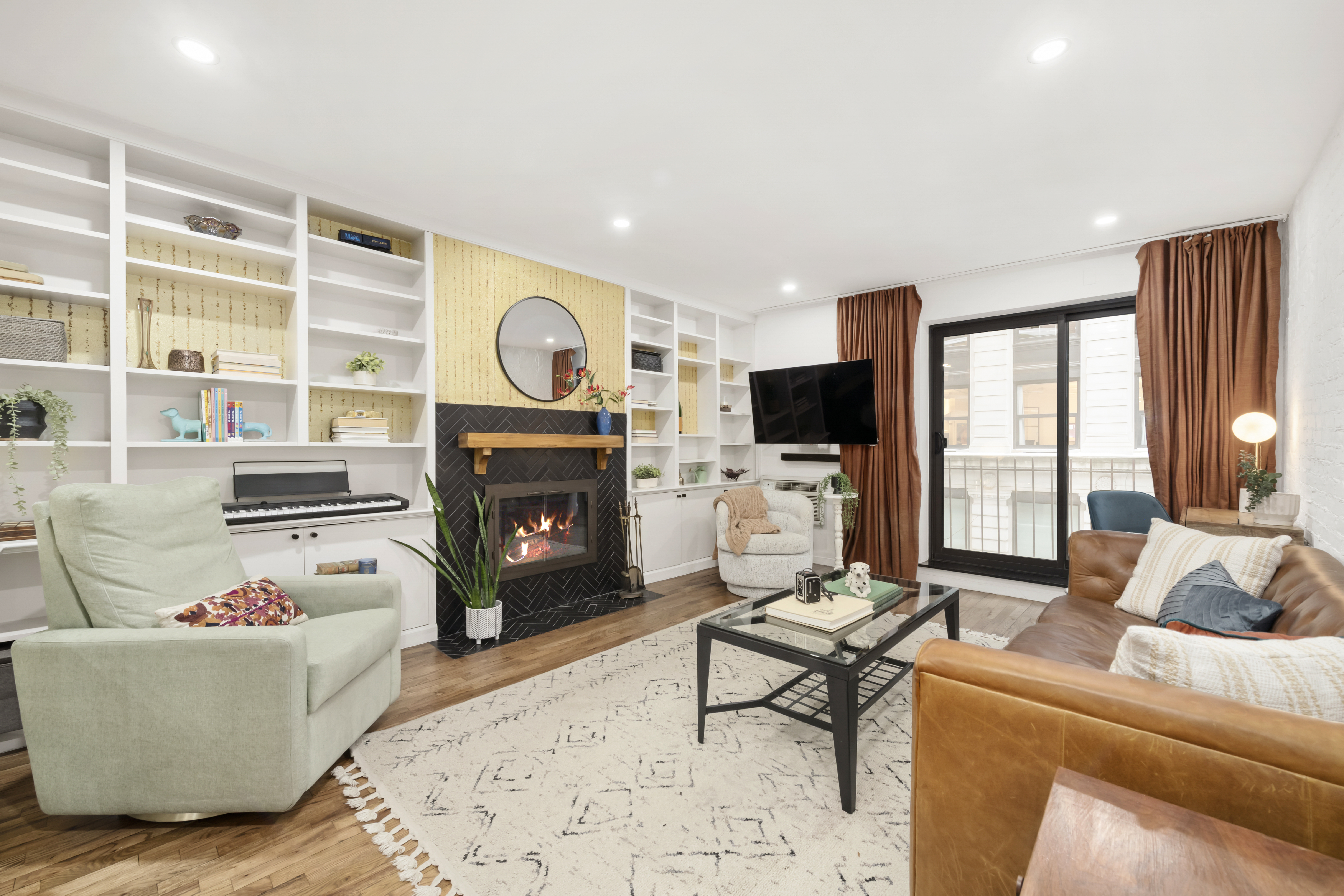 a living room with furniture a fireplace and a flat screen tv