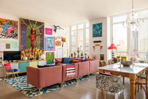 a living room with furniture and a floor to ceiling window