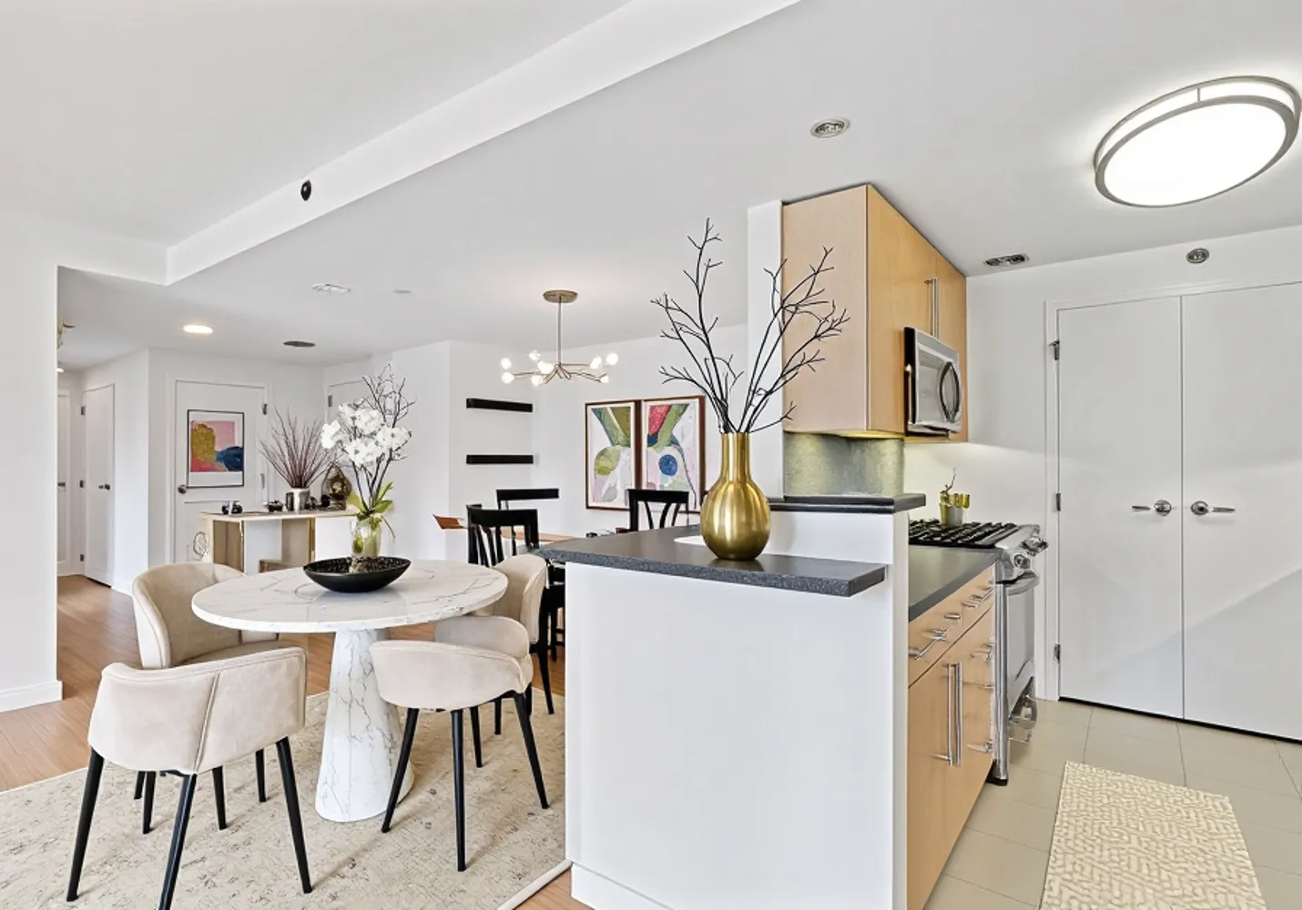 40 West 116th Street, Unit B503 Manhattan, NY 10026 - Photo 4 of 36 a kitchen with stainless steel appliances kitchen island granite countertop a sink and cabinets