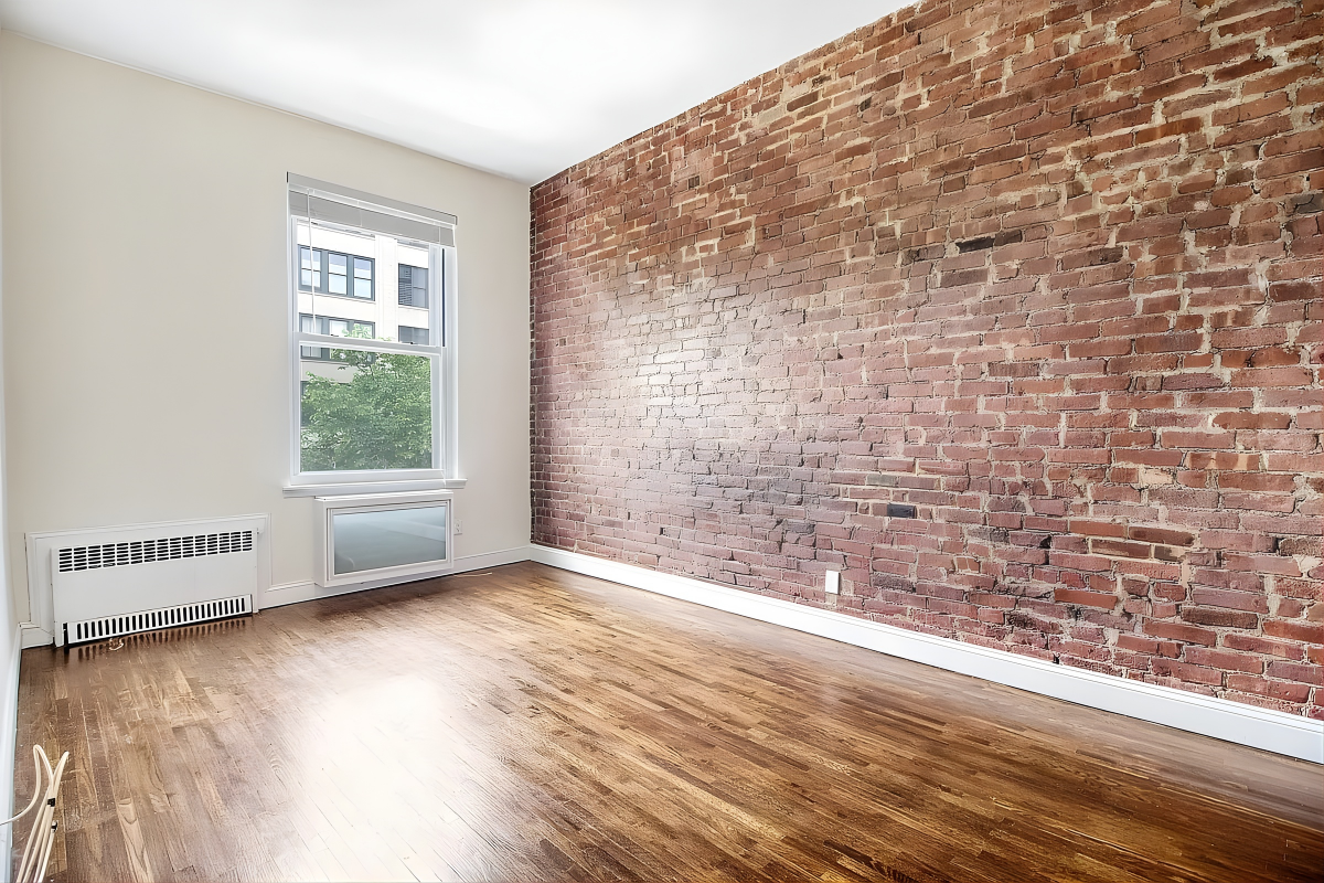 219 West 14th Street, Unit 4F Manhattan, NY 10011 - Photo 5 of 7 a view of an empty room with wooden floor and a window