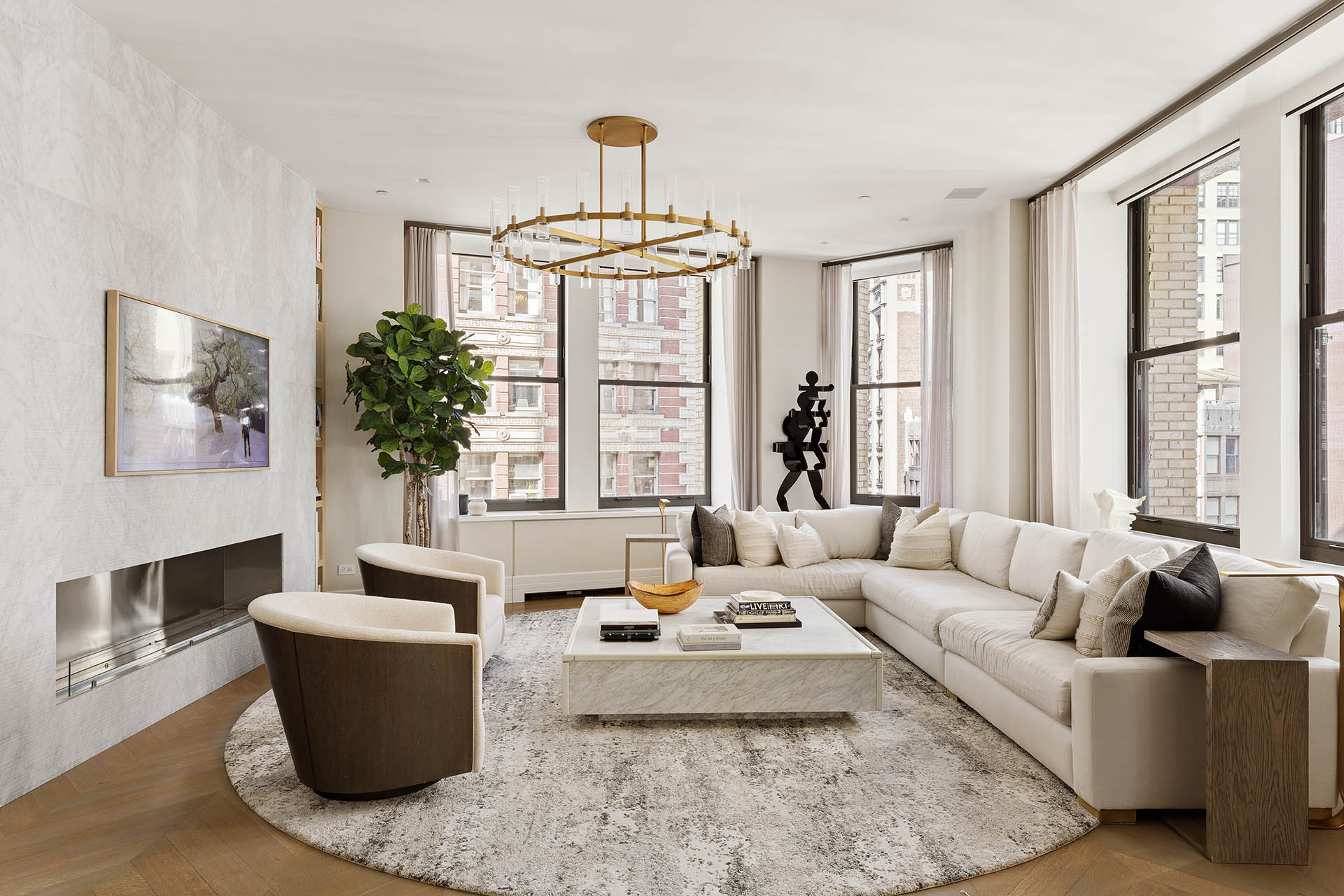 212 5th Avenue, Unit 9B Manhattan, NY 10010 - Photo 2 of 16 a living room with furniture and a chandelier