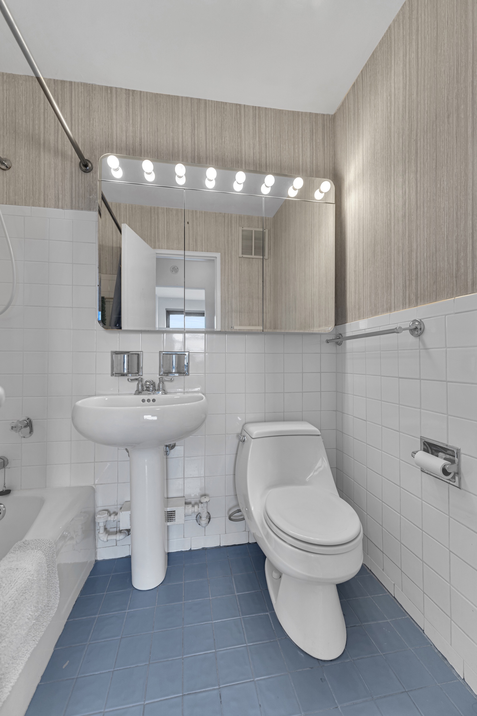 205 West End Avenue, Unit 23E Manhattan, NY 10023 - Photo 10 of 15 a bathroom with a sink toilet and a mirror