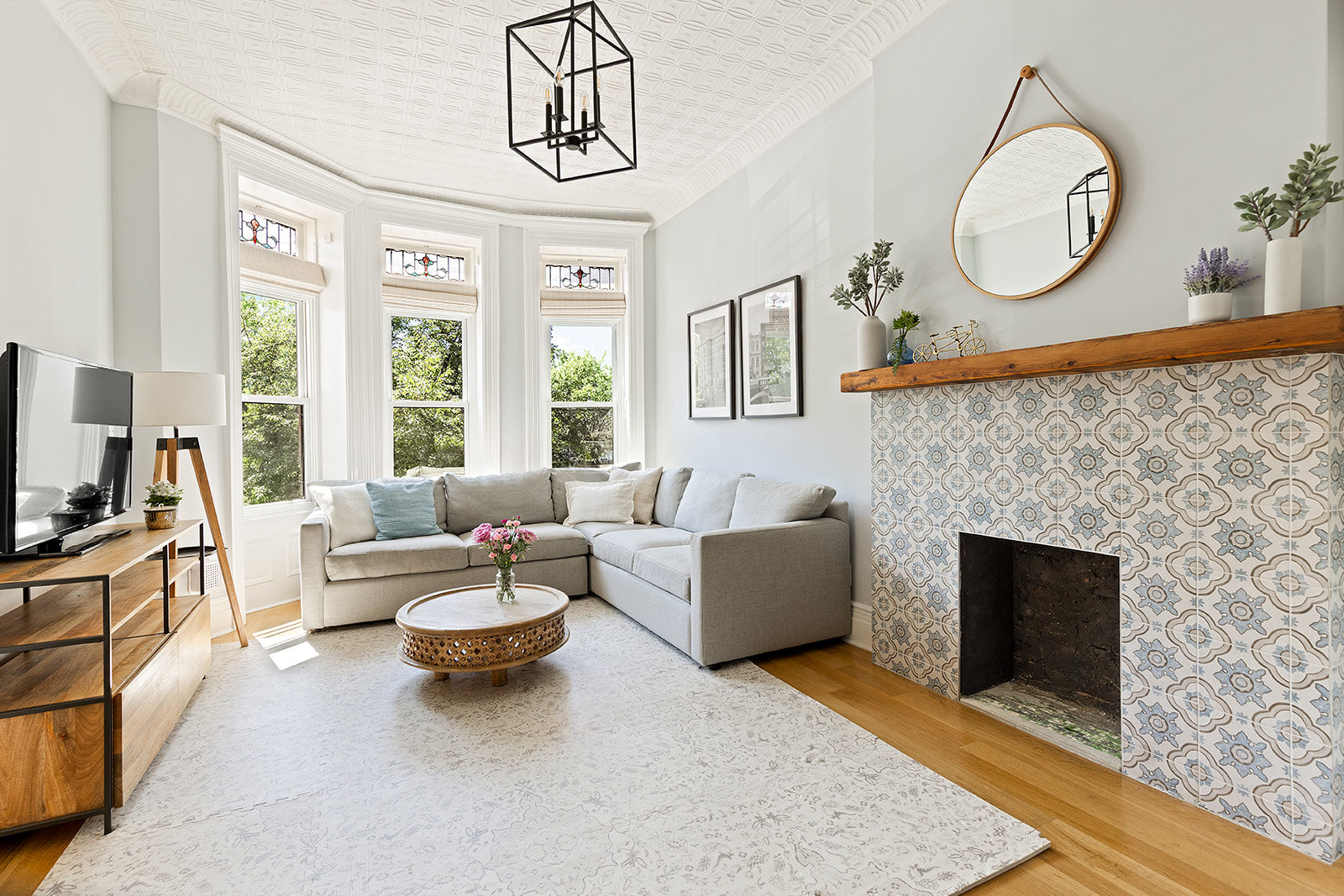 a living room with furniture a fireplace and a large window