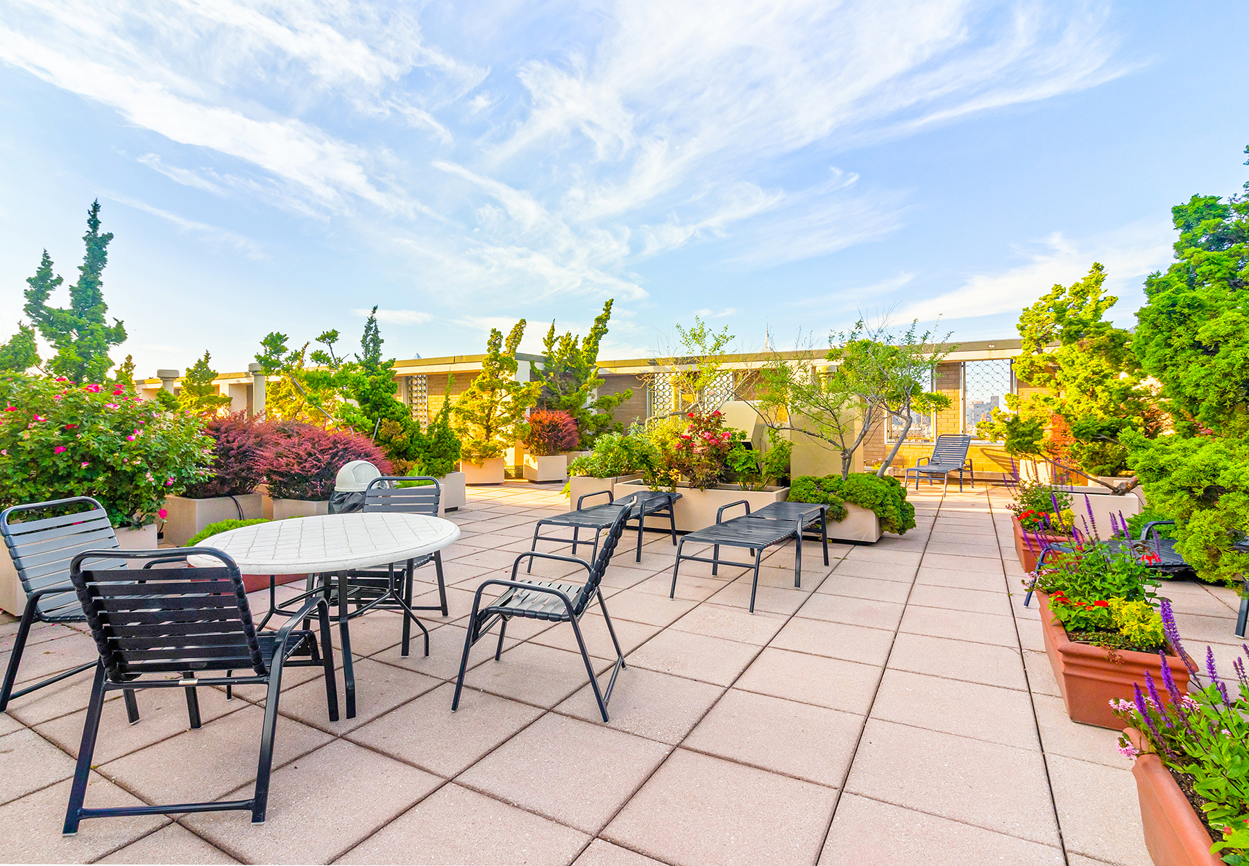 60 East 8th Street, Unit 24J Manhattan, NY 10003 - Photo 12 of 16 a view of a terrace with furniture and garden